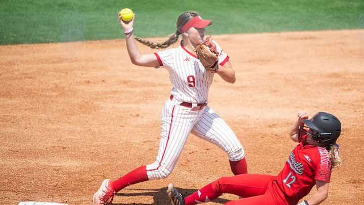 Indiana's Taryn Kern (9) throws to first after tagging Louisville's Easton Lotus (12) out at second base.