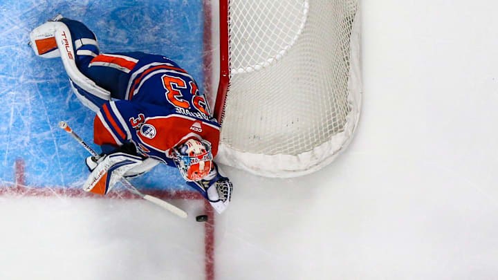 Bakersfield goaltender Olivier Rodrigue (33) drops to the ice to get on top of the puck during the