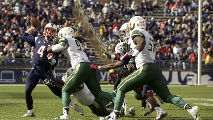 Oct 17, 2015; East Hartford, CT, USA; Connecticut Huskies quarterback Bryant Shirreffs (4) passes the ball under pressure from the South Florida Bulls defense in the second half at Rentschler Field. USF defeated UConn 28-20. Mandatory Credit: David Butler II-USA TODAY Sports