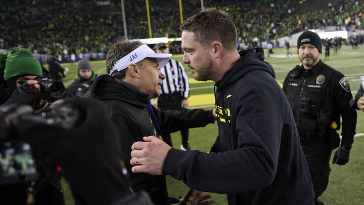 Nov 30, 2024; Eugene, Oregon, USA; Washington Huskies head coach Jedd Fisch, left, congratulates Oregon Ducks head coach Dan Lanning on his win after a game at Autzen Stadium. Mandatory Credit: Troy Wayrynen-Imagn Images