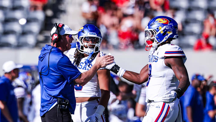 Nov 8, 2025; Tucson, Arizona, USA; Kansas Jayhawks defensive end Dakyus Brinkley (9) high fives head coach Lance Leipold during the second quarter of the game against the Arizona Wildcats at Arizona Stadium. Mandatory Credit: Aryanna Frank-Imagn Images Nov 8, 2025; Tucson, Arizona, USA; Kansas Jayhawks defensive end Dakyus Brinkley (9) high fives head coach Lance Leipold during the second quarter of the game against the Arizona Wildcats at Arizona Stadium. Mandatory Credit: Aryanna Frank-Imagn Images