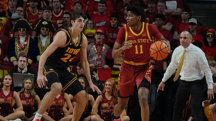 Iowa State Cyclones guard Dominick Nelson (11) drives with the ball around Iowa Hawkeyes guard Tate Sage (24) during the first half in the men’s basketball Cy-Hawk series on Dec. 11, 2025, in Ames, Iowa.