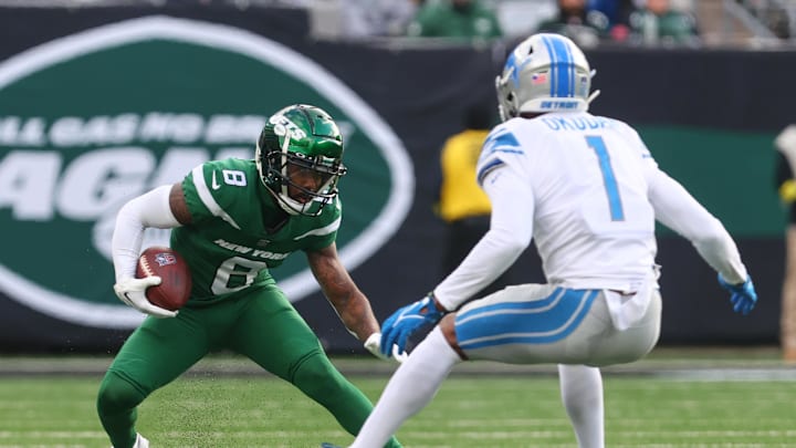 Dec 18, 2022; New York Jets wide receiver Elijah Moore (8) runs past Detroit Lions cornerback Jeff Okudah.