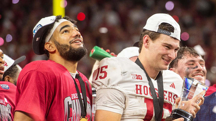 Indiana's Fernando Mendoza (15) holds the MVP trophy next to Elijah Sarratt after the Indiana versus Ohio State Big Ten Championship football game at Lucas Oil Stadium on Saturday, Dec. 6, 2025. Indiana's Fernando Mendoza (15) holds the MVP trophy next to Elijah Sarratt after the Indiana versus Ohio State Big Ten Championship football game at Lucas Oil Stadium on Saturday, Dec. 6, 2025.