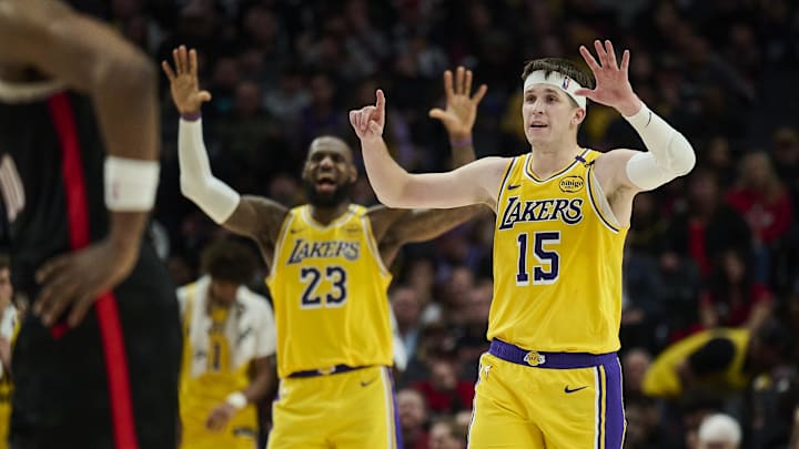Feb 20, 2025; Portland, Oregon, USA; Los Angeles Lakers guard Austin Reaves (15) and forward LeBron James (23) signal to teammates during the second half against the Portland Trail Blazers at Moda Center. Mandatory Credit: Troy Wayrynen-Imagn Images
