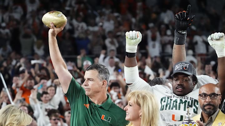 Miami Hurricanes head coach Mario Cristobal lifts the trophy after defeating Ole Miss 31-27 in the Vrbo Fiesta Bowl and CFP semifinal game at State Farm Stadium on Jan. 8, 2026, in Glendale.