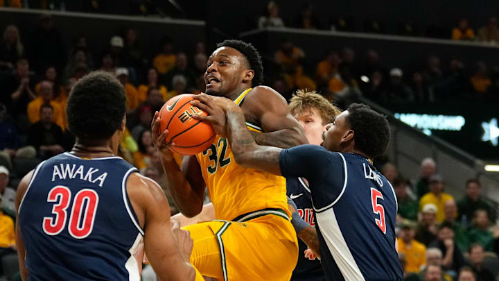Feb 17, 2025; Waco, Texas, USA; Baylor Bears guard Jalen Celestine (32) is fouled driving to the basket by Arizona Wildcats guard KJ Lewis (5) during the first half at Paul and Alejandra Foster Pavilion. Mandatory Credit: Chris Jones-Imagn Images
