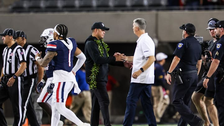 Aug 30, 2025; Tucson, Arizona, USA; Hawaii Rainbow Warriors head coach Timmy Chang shakes hands with Arizona Wildcats head coach Brent Brennan at the end of the game at Arizona Stadium. Mandatory Credit: Aryanna Frank-Imagn Images