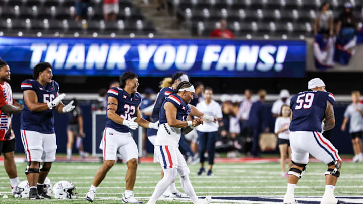 Aug 30, 2025; Tucson, Arizona, USA; Arizona Wildcats head coach Noah Fifita (1) dances with his teammates after they defeat the Hawaii Rainbow Warriors at the end of the game at Arizona Stadium. Mandatory Credit: Aryanna Frank-Imagn Images
