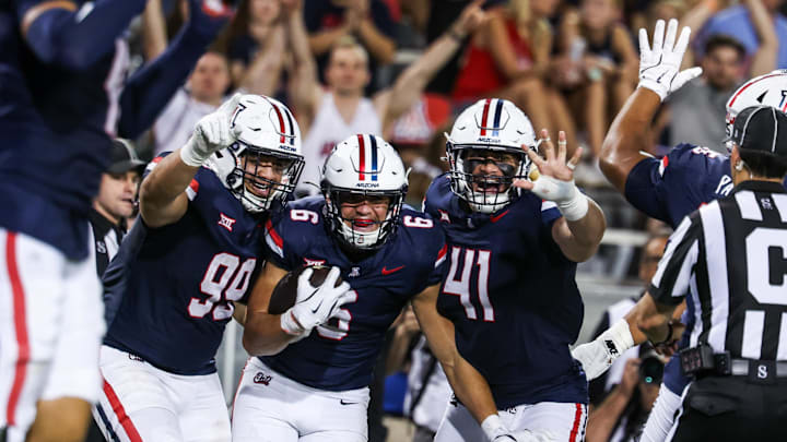 Aug 30, 2025; Tucson, Arizona, USA; Arizona Wildcats defensive lineman Mays Pese (99), linebacker Taye Brown (6), and defensive lineman Julian Saviinaea (41) all celebrate after they intercept the ball from the Hawaii Rainbow Warriors during the third quarter of the game at Arizona Stadium. Mandatory Credit: Aryanna Frank-Imagn Images