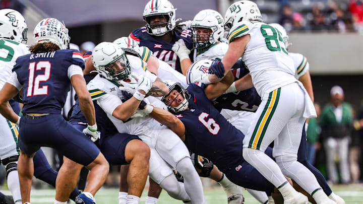 Nov 22, 2025; Tucson, Arizona, USA; Arizona Wildcats linebacker Taye Brown (6) attempts to take the ball out of the hands of the Baylor Bears during the fourth quarter of the game at Casino Del Sol Stadium. Mandatory Credit: Aryanna Frank-Imagn Images Nov 22, 2025; Tucson, Arizona, USA; Arizona Wildcats linebacker Taye Brown (6) attempts to take the ball out of the hands of the Baylor Bears during the fourth quarter of the game at Casino Del Sol Stadium. Mandatory Credit: Aryanna Frank-Imagn Images