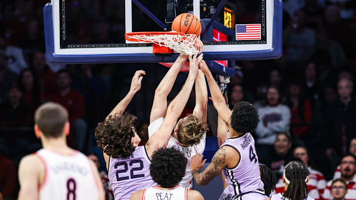 Jan 7, 2026; Tucson, Arizona, USA; Arizona Wildcats center Motiejus Krivas (13) tips the ball in while Kansas State Wildcats center Dorin Buca (22) and guard P.J. Haggerty (4) fails to block him during the first half of the game at McKale Memorial Center. Mandatory Credit: Aryanna Frank-Imagn Images