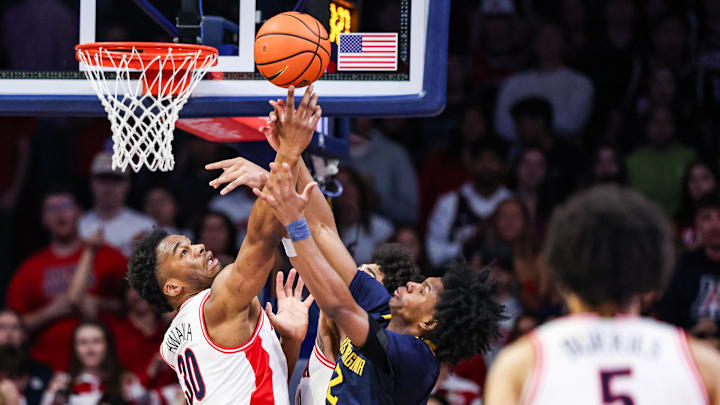 Jan 24, 2026; Tucson, Arizona, USA; Arizona Wildcats forward Tobe Awaka (30) and West Virginia Mountaineers guard Amir Jenkins (2) jump for the ball during the first half of the game at McKale Memorial Center. Mandatory Credit: Aryanna Frank-Imagn Images