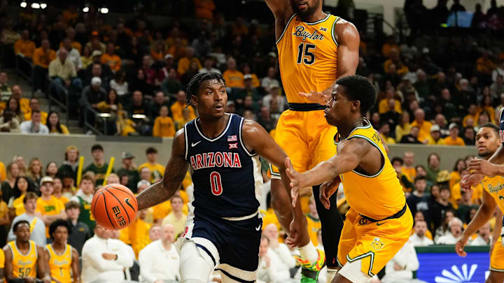 Feb 17, 2025; Waco, Texas, USA;  Arizona Wildcats guard Jaden Bradley (0) looks to pass against Baylor Bears guard VJ Edgecombe (7) during the first half at Paul and Alejandra Foster Pavilion. Mandatory Credit: Chris Jones-Imagn Images
