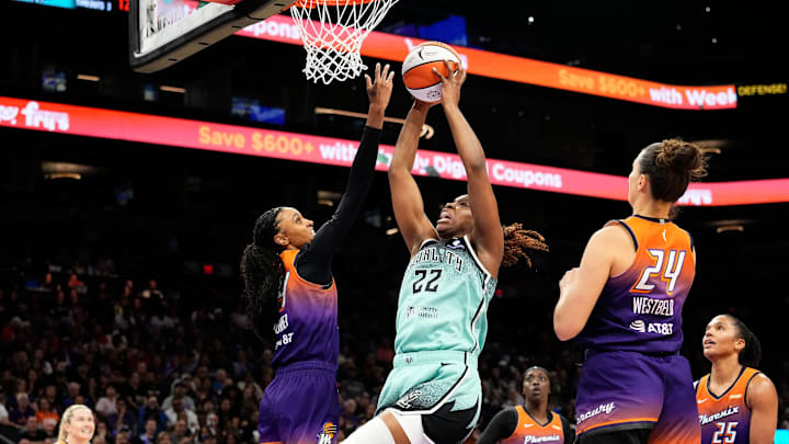 New York Liberty forward Kennedy Burke (22) drives to the basket against Phoenix Mercury forward DeWanna Bonner (14) in the second half of Game One of the 2025 WNBA Playoffs first round at PHX Arena on Sept. 14, 2025.