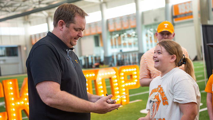 Haley Paul, right, smiles with excitement as Tennessee football head coach Josh Heupel, left, autographs an item for her during the Big Orange Caravan held at the Neyland-Thompson Sports Complex on the University of Tennessee's campus in Knoxville on Thursday, April 20, 2023.

Kns Big Orange Caravan Bp