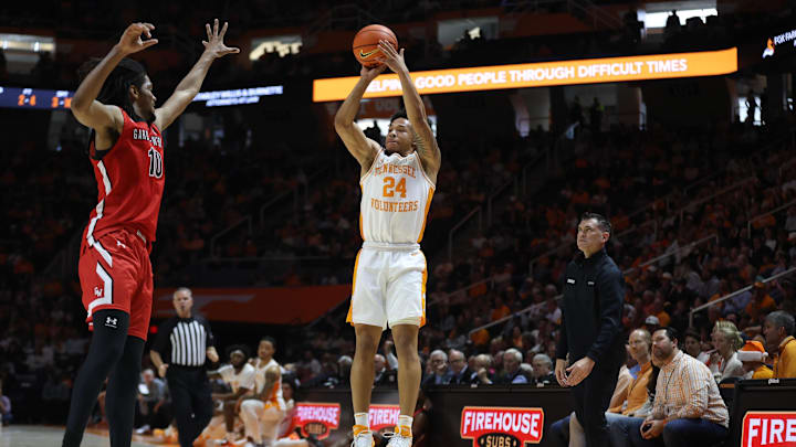 Dec 21, 2025; Knoxville, Tennessee, USA; Tennessee Volunteers guard Troy Henderson (24) shoots a three pointer against Gardner-Webb Runnin' Bulldogs guard Curtis Williams (10) during the first half at Thompson-Boling Arena at Food City Center. Mandatory Credit: Randy Sartin-Imagn Images