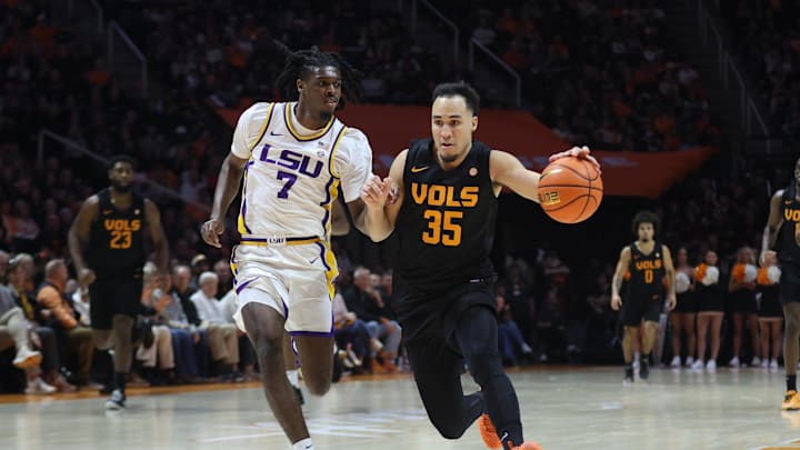 Feb 14, 2026; Knoxville, Tennessee, USA;  Tennessee Volunteers guard Ethan Burg (35) brings the ball up court against Louisiana State Tigers guard PJ Carter (7) during the first half at Thompson-Boling Arena at Food City Center. Mandatory Credit: Randy Sartin-Imagn Images