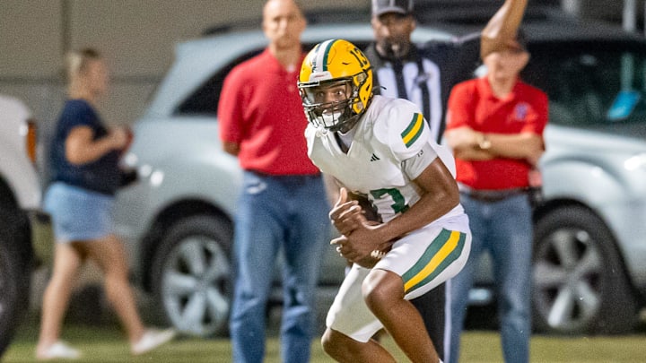 Braylon Calais 13 runs the ball as the Notre Dame Pios take on the Cecilia Bulldogs. Friday, Oct. 4, 2024.