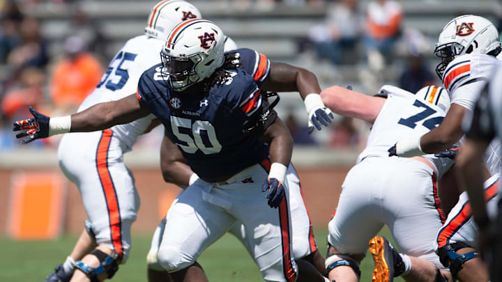 Auburn Tigers defensive lineman Marcus Harris (50) breaks through the line during the A-Day spring