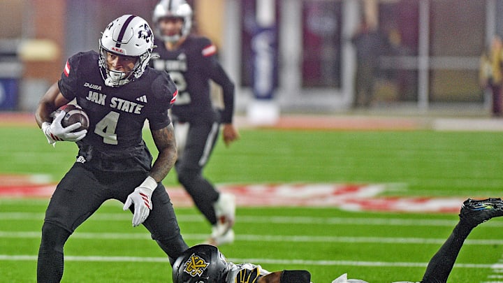 Jax State's Cam Cook tries to evade the tackle of Kennesaw State's Isaac Paul during the C-USA Championship at AmFirst Stadium in Jacksonville, Alabama December 5, 2025. (Dave Hyatt / Hyatt Media LLC)