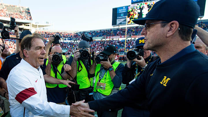 Alabama head coach Nick Saban greets Michigan head coach Jim Harbaugh