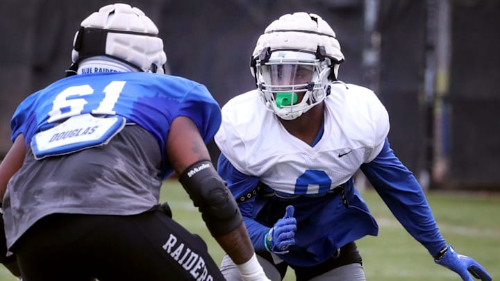 MTSU defensive end Richard Kinley (0) looks for a way to get around an MTSU offensive lineman