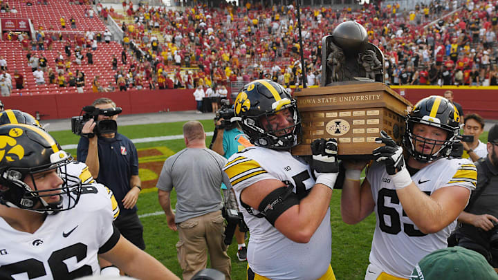 Iowa Football team celebrates with Cy-Hawk trophy after winning 20-13 over Iowa State at the Jack Trice Stadium on Saturday, Sept. 9, 2023, in Ames, Iowa.