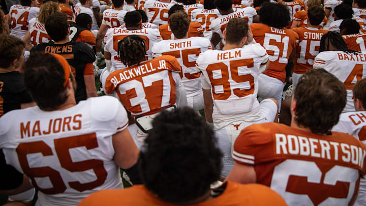 The Texas Longhorns gather on the field following the Longhorns' spring Orange and White game at Darrell K Royal Texas Memorial Stadium.