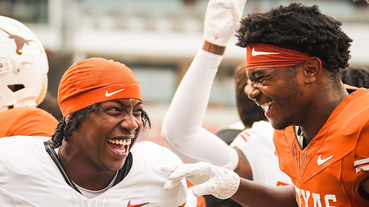 Texas Longhorns running back Ky Woods (29) celebrates with teammate defensive back Jelani McDonald (25).