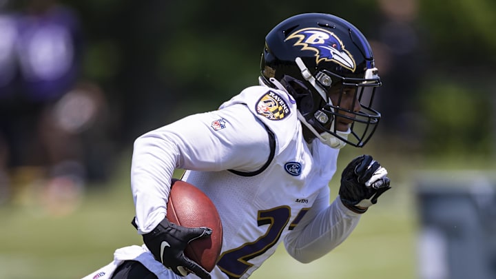 May 26, 2021; Owings Mills, Maryland, USA; Baltimore Ravens running back J.K. Dobbins (27) carries the ball during an OTA at Under Armour Performance Center. Mandatory Credit: Scott Taetsch-Imagn Images