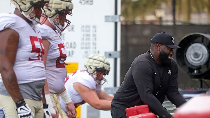 FSU Offensive Line Coach Alex Atkins helps with drills during a practice on Monday, Aug. 8, 2022 in Tallahassee, Fla.