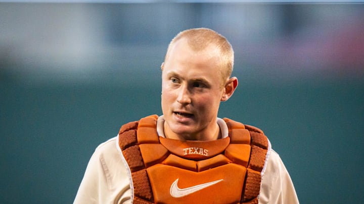 Texas catcher Kimble Schuessler (10) heads to the plate before the first inning of the Longhorns'