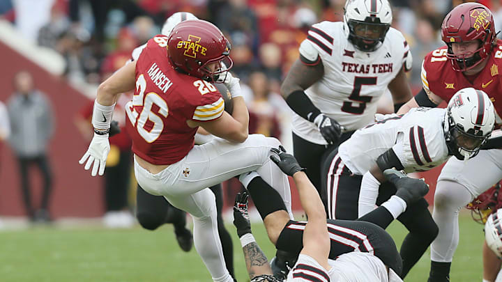 Iowa State running back Carson Hansen (26) battles for few yards as he gets tackled by Texas Tech's Jacob Rodriguez (10) during their game at Jack Trice Stadium on Saturday, Nov. 2, 2024, in Ames, Iowa.