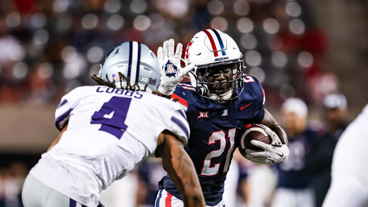 Sep 12, 2025; Tucson, Arizona, USA; Arizona Wildcats running back Ismail Mahdi (21) runs the ball while Kansas State Wildcats safety Daniel Cobbs (4) defends during the fourth quarter at Arizona Stadium. Mandatory Credit: Aryanna Frank-Imagn Images