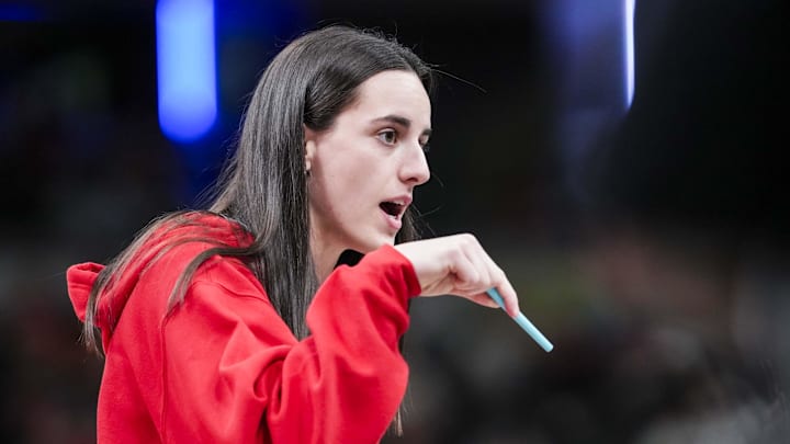 Jun 3, 2025; Indianapolis, Indiana, USA;  Indiana Fever guard Caitlin Clark (22) talks with an official during a timeout at a game between the Indiana Fever and the Washington Mystics at Gainbridge Fieldhouse in Indianapolis.