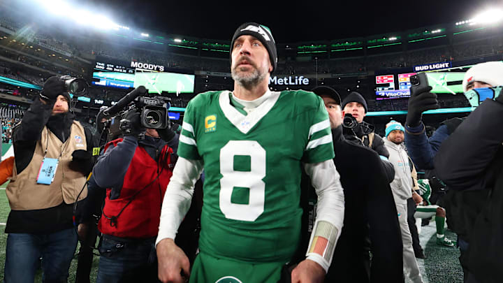 Jan 5, 2025; East Rutherford, New Jersey, USA; New York Jets quarterback Aaron Rodgers (8) walks on the field after the Jets win over the Miami Dolphins at MetLife Stadium. Mandatory Credit: Ed Mulholland-Imagn Images