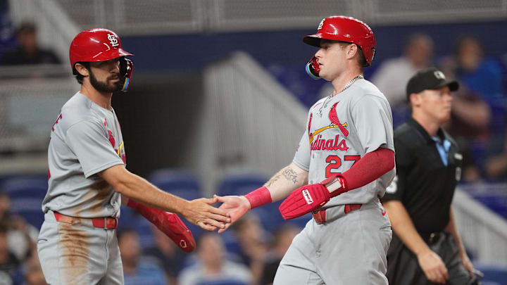 Aug 19, 2025; Miami, Florida, USA;  St. Louis Cardinals second baseman Thomas Saggese (25) congratulates center fielder Nathan Church (27) on scoring a run in the second inning against the Miami Marlins at loanDepot Park. Mandatory Credit: Jim Rassol-Imagn Images