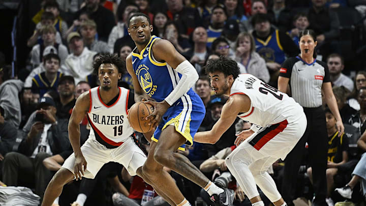 Apr 11, 2024; Portland, Oregon, USA; Golden State Warriors forward Jonathan Kuminga (00) looks to pass during the second half against Portland Trail Blazers guard Ashton Hagans (19), and forward Justin Minaya (24) at Moda Center. Mandatory Credit: Troy Wayrynen-Imagn Images