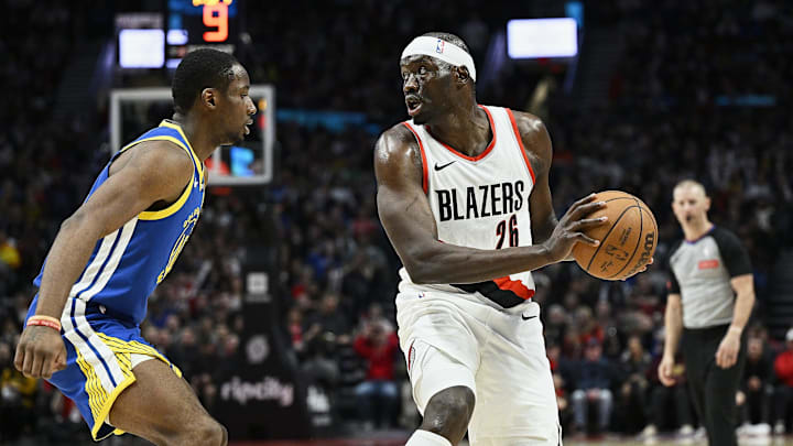 Apr 11, 2024; Portland, Oregon, USA; Portland Trail Blazers center Duop Reath (26) looks to pass the ball during the second half against Golden State Warriors forward Jonathan Kuminga (00) at Moda Center. Mandatory Credit: Troy Wayrynen-Imagn Images