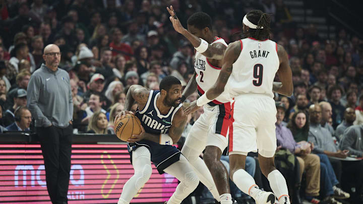 Dec 28, 2024; Portland, Oregon, USA; Dallas Mavericks guard Kyrie Irving (11) runs into a double team defense by Portland Trail Blazers center Deandre Ayton (2) and forward Jerami Grant (9) during the first half at Moda Center. Mandatory Credit: Troy Wayrynen-Imagn Images