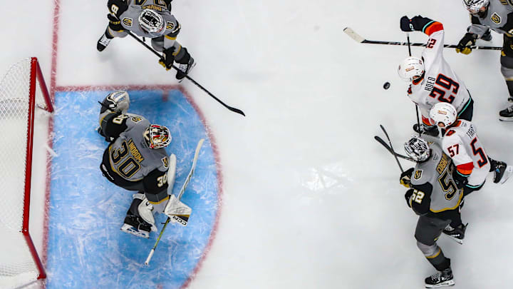 Coachella Valley Firebirds center Lleyton Roed (29) fights to try to get a shot off as right wing Jagger Firkus (57) gets tangled up with Henderson Silver Knights defender Dylan Coghlan during the first period of their game at Acrisure Arena in Palm Desert, Calif., Wednesday, Jan. 7, 2026.