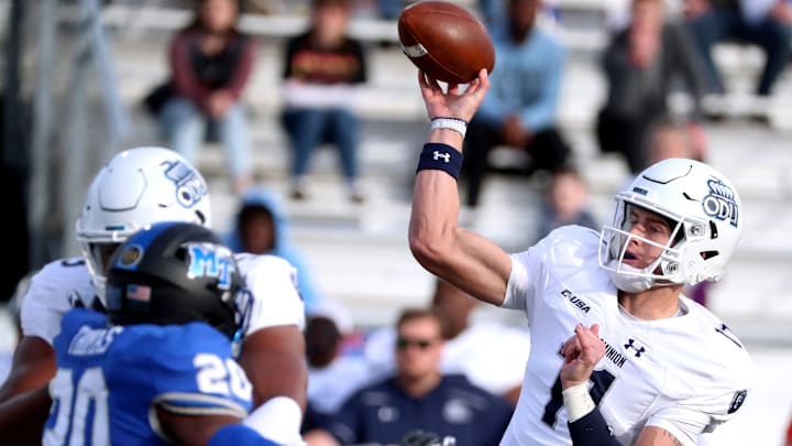 Old Dominion quarterback Hayden Wolff (11) passes the ball as MTSU linebacker DQ Thomas (20) puts on