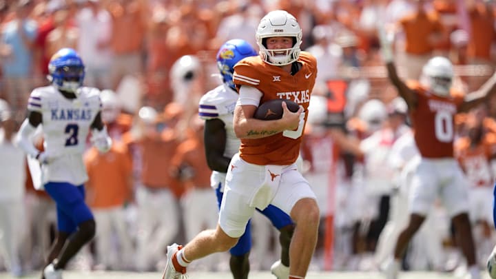 Texas Longhorns quarterback Quinn Ewers runs for a touchdown against the Kansas Jayhawks in the
