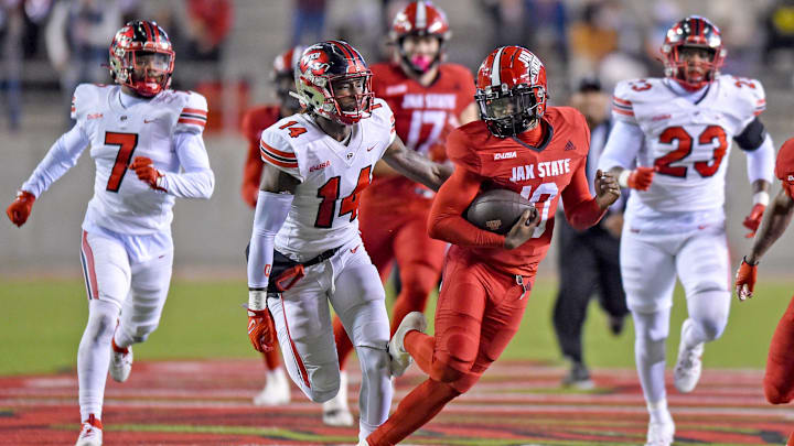 Jacksonville State's Zion Webb tries to evade the tackle of Western Kentucky's Davion Williams