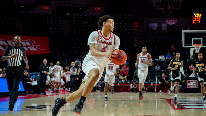 Kobe Julien (No. 4) takes it to the basket as Louisiana men's basketball takes on Xavier in the