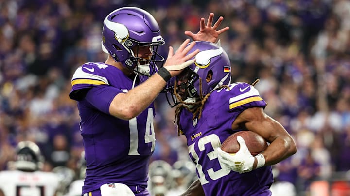 Dec 8, 2024; Minneapolis, Minnesota, USA; Minnesota Vikings running back Aaron Jones (33) celebrates his running touchdown with quarterback Sam Darnold (14) during the fourth quarter against the Atlanta Falcons at U.S. Bank Stadium. Mandatory Credit: Matt Krohn-Imagn Images
