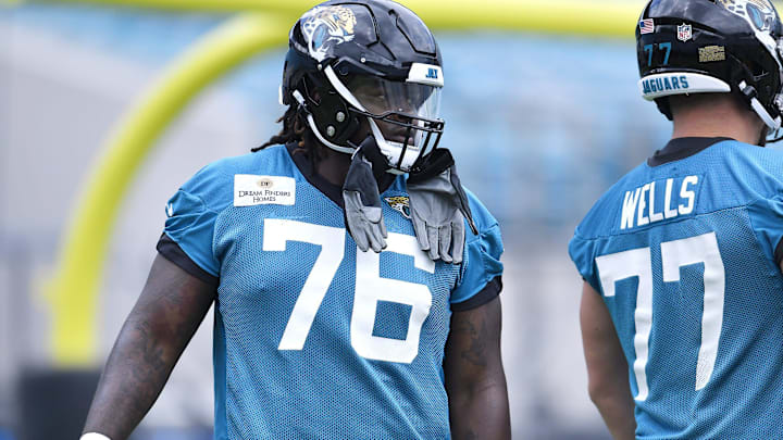 Jacksonville Jaguars offensive tackle Anton Harrison (76) and first round draft pick with teammates
