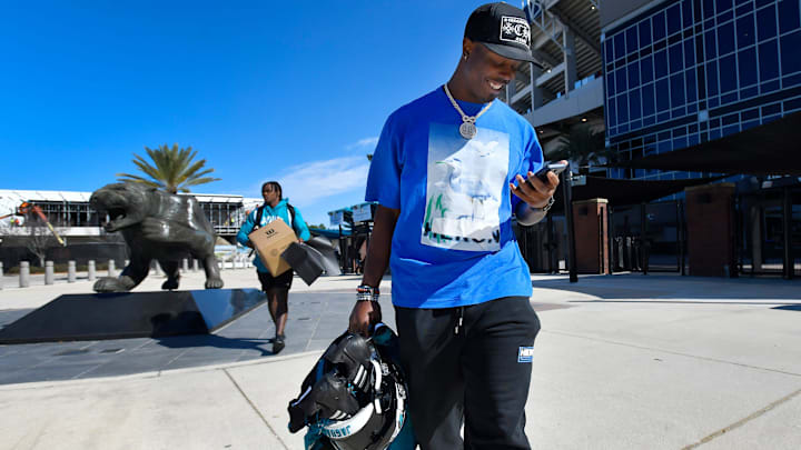Jacksonville Jaguars running back Travis Etienne Jr. (1) leaves the stadium after cleaning out his locker.