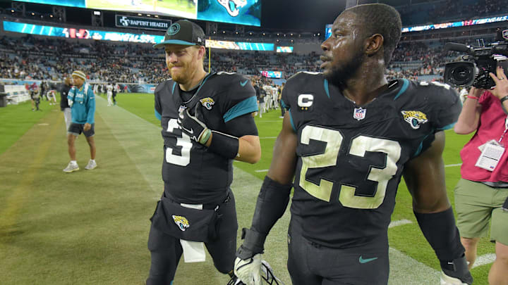 Jacksonville Jaguars back-up quarterback C.J. Beathard (3) and linebacker Foyesade Oluokun (23)